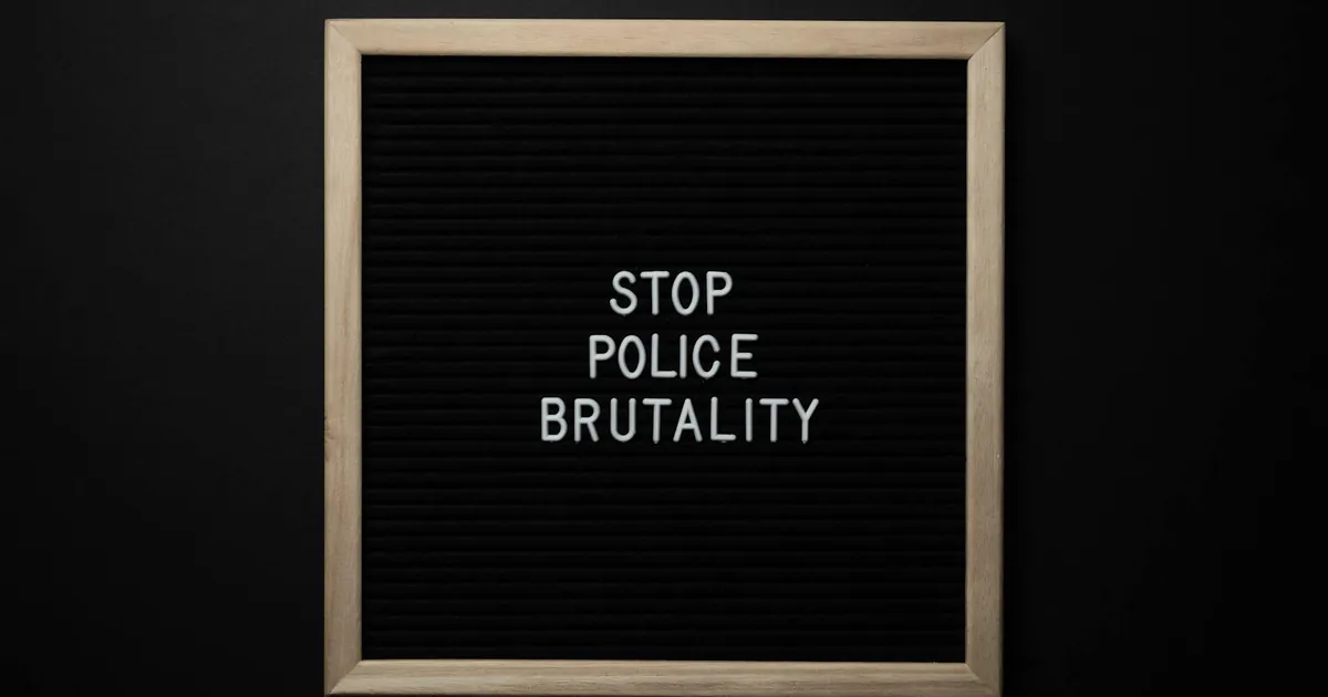 Overhead view wooden frame with white inscription about social injustice on black background