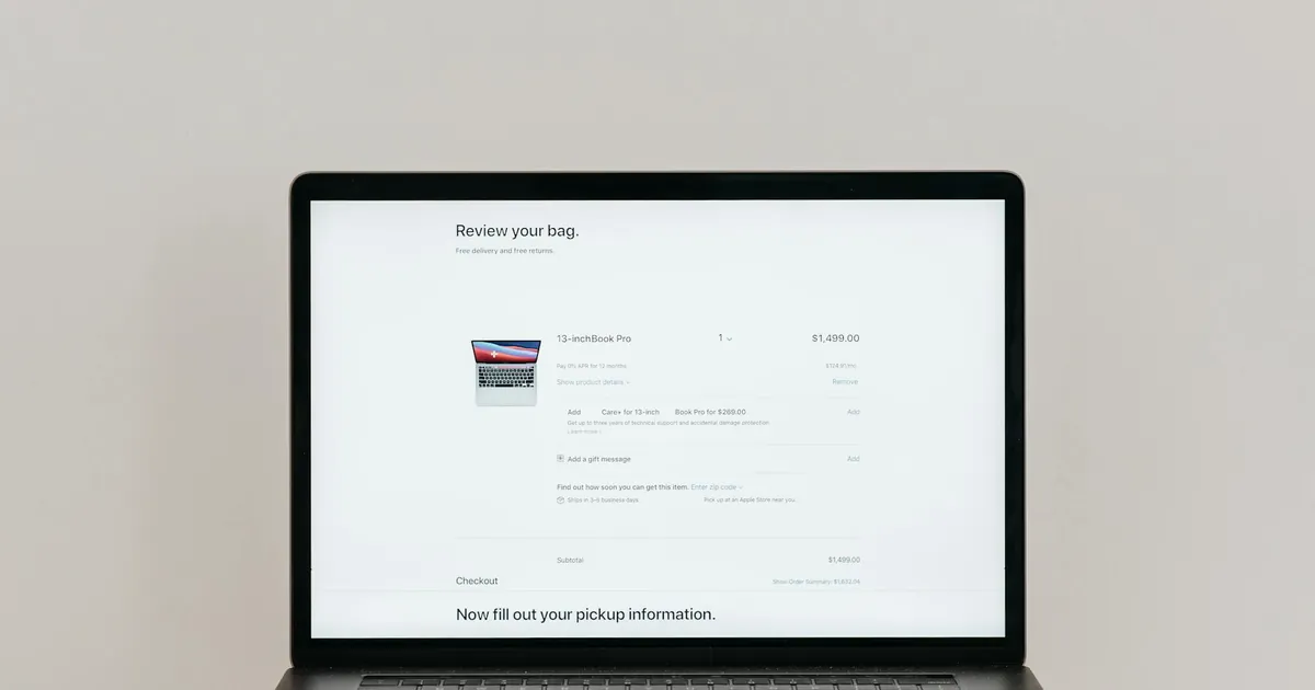 Minimalist laptop showing an online checkout screen on a white background, ideal for tech context.