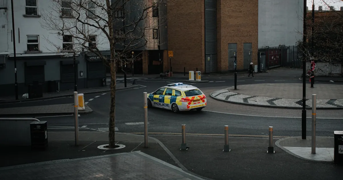 Police car driving around a city intersection.