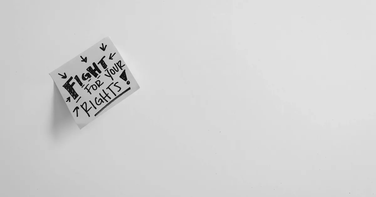 Sticky note with 'Fight for your rights' message on white surface.