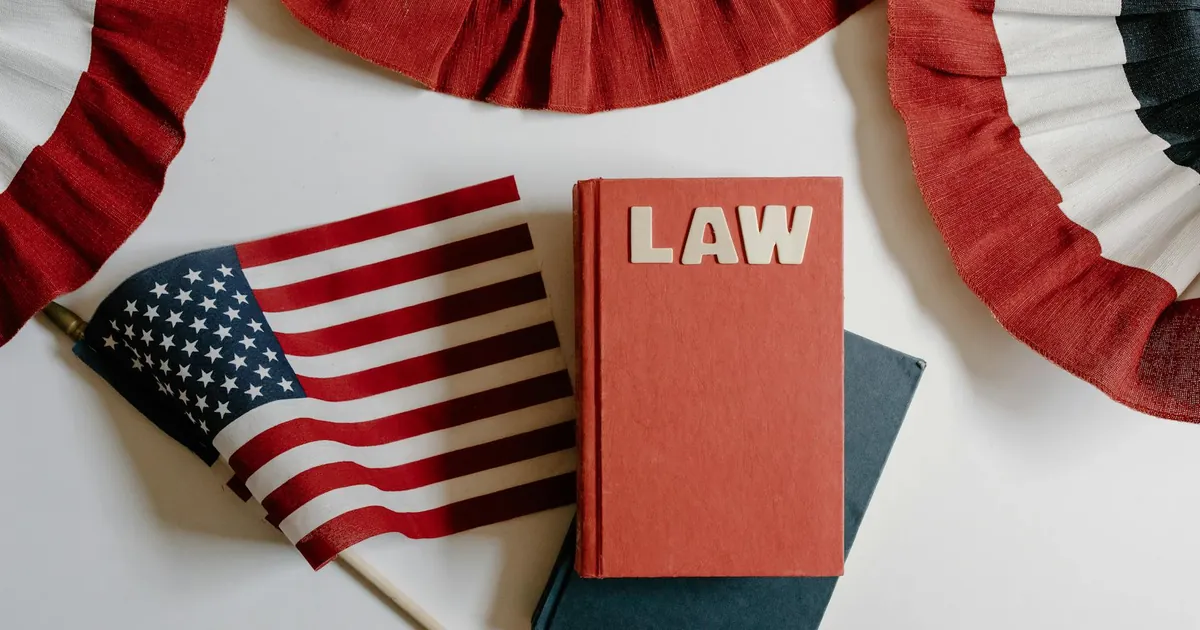 American flag with a law book, symbolizing independence and politics.